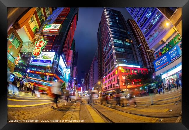 Hong Kong illuminated buildings busy pedestrian ci Framed Print by Spotmatik 