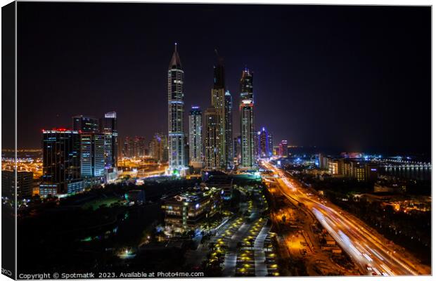 Night illuminated view Skyscrapers Sheikh Zayed road Dubai  Canvas Print by Spotmatik 
