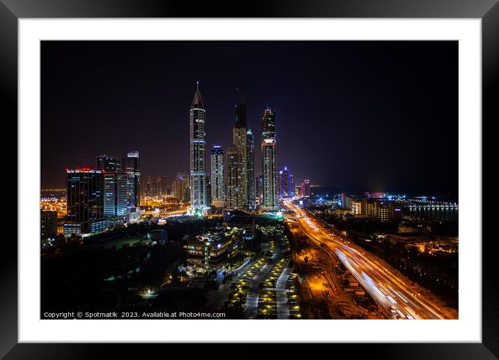 Night illuminated view Skyscrapers Sheikh Zayed road Dubai  Framed Mounted Print by Spotmatik 