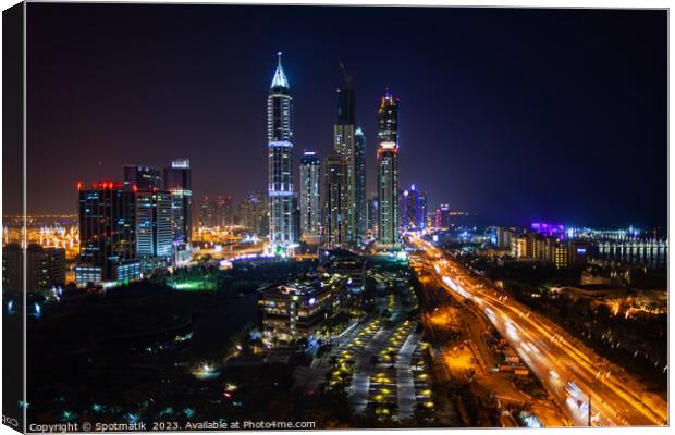 Night Dubai illuminated view of modern city Skyscrapers Canvas Print by Spotmatik 
