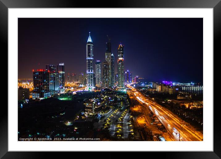 Night Dubai illuminated view of modern city Skyscrapers Framed Mounted Print by Spotmatik 