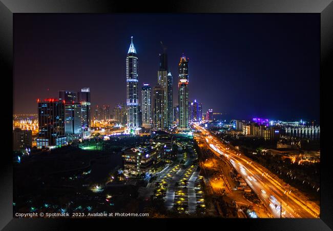 Night Dubai illuminated view of modern city Skyscrapers Framed Print by Spotmatik 
