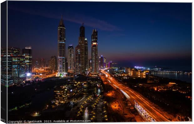 Dubai dusk illuminated view Sheikh Zayed city skyscrapers  Canvas Print by Spotmatik 