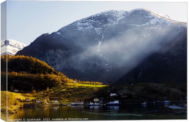 Norwegian sunlight beaming though light mist glacial fjord  Canvas Print by Spotmatik 