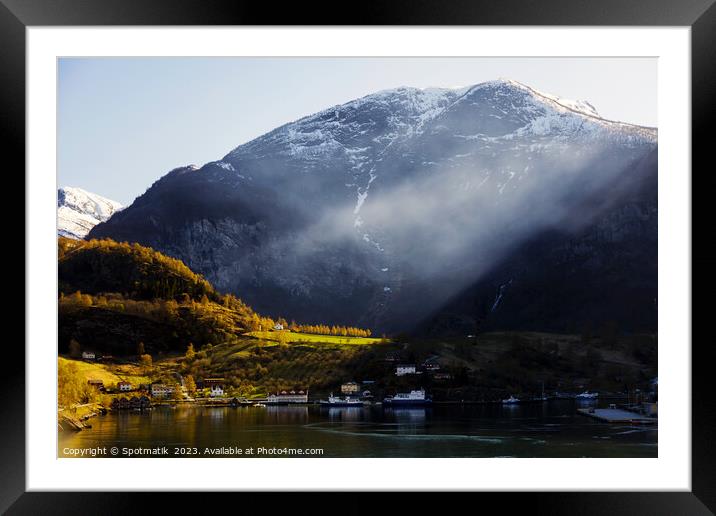 Norwegian sunlight beaming though light mist glacial fjord  Framed Mounted Print by Spotmatik 