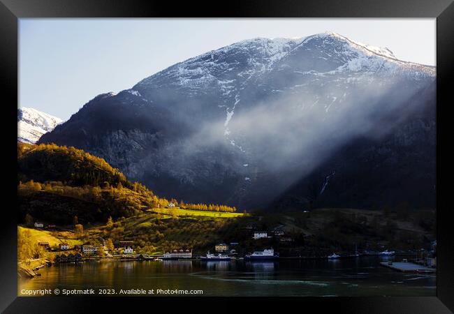 Norwegian sunlight beaming though light mist glacial fjord  Framed Print by Spotmatik 