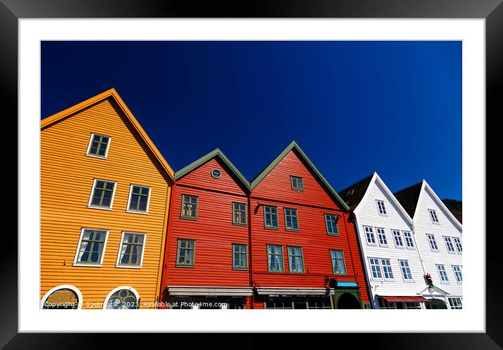 Bergen Norway a colorful wooden clad boat houses  Framed Mounted Print by Spotmatik 