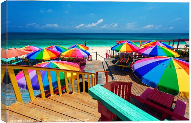 Beach umbrellas in the tropical sunshine Bahamas Caribbean Canvas Print by Spotmatik 