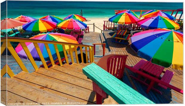Umbrellas in the sun tropical beach Bahamas Caribbean Canvas Print by Spotmatik 