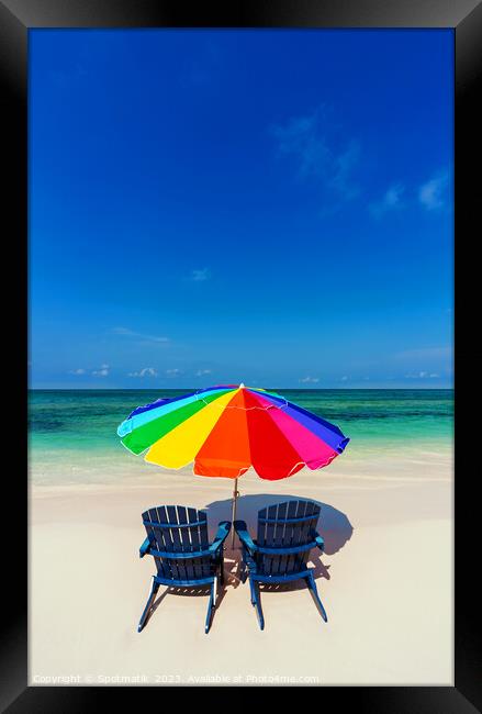 Bahamas beach umbrella and chairs on sandy beach  Framed Print by Spotmatik 