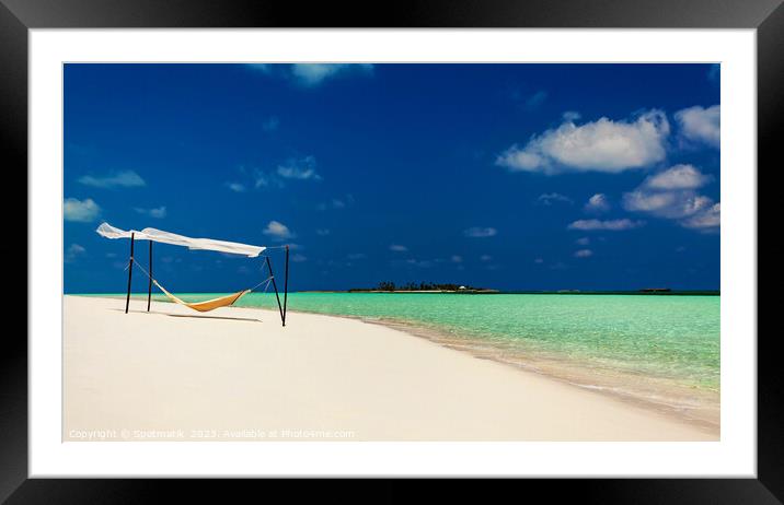 Hammock swaying in the breeze over white sands  Framed Mounted Print by Spotmatik 