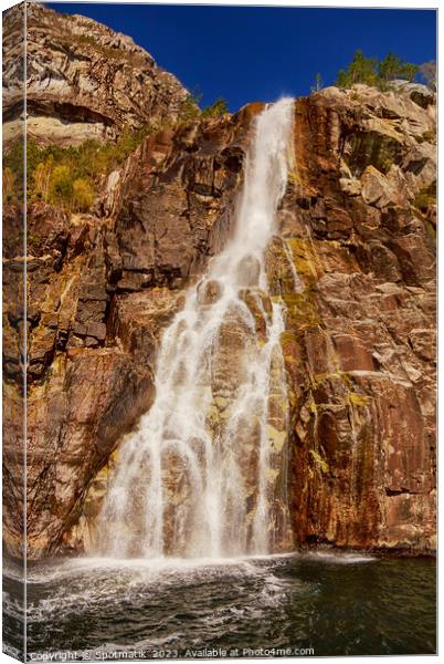 View of Norwegian waterfall cascading into Lysefjorden fjord  Canvas Print by Spotmatik 