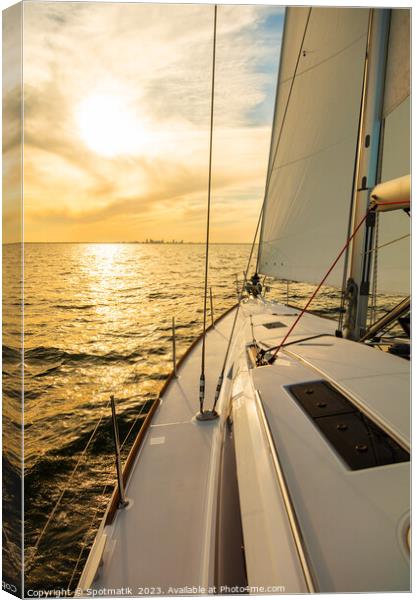 Luxury yacht sailing towards distant horizon at sunset Canvas Print by Spotmatik 