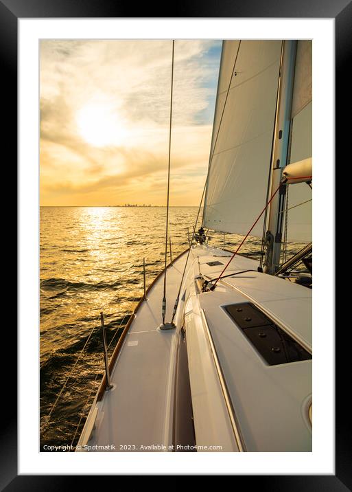 Luxury yacht sailing towards distant horizon at sunset Framed Mounted Print by Spotmatik 