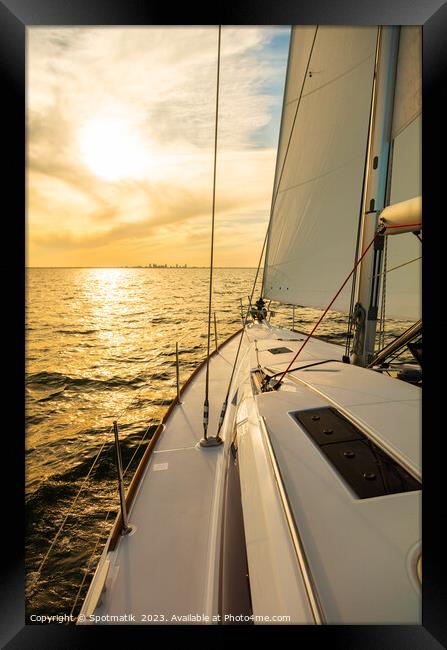 Luxury yacht sailing towards distant horizon at sunset Framed Print by Spotmatik 