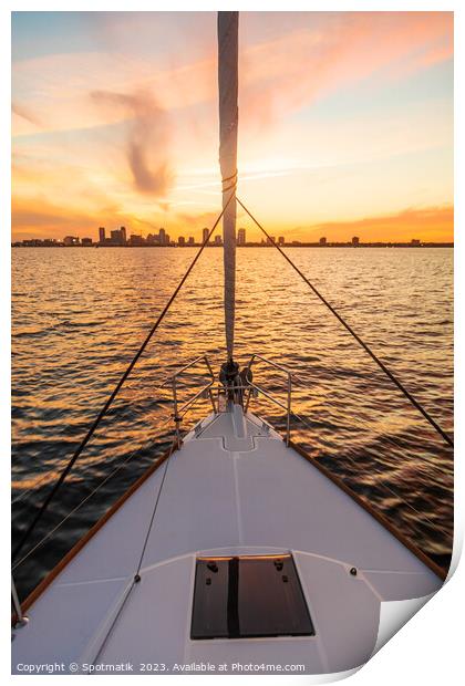 Bow of yacht sailing towards cityscape at sunrise Print by Spotmatik 