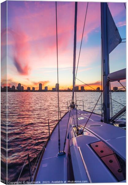 Sailing luxury yacht at sunset with cityscape view Canvas Print by Spotmatik 