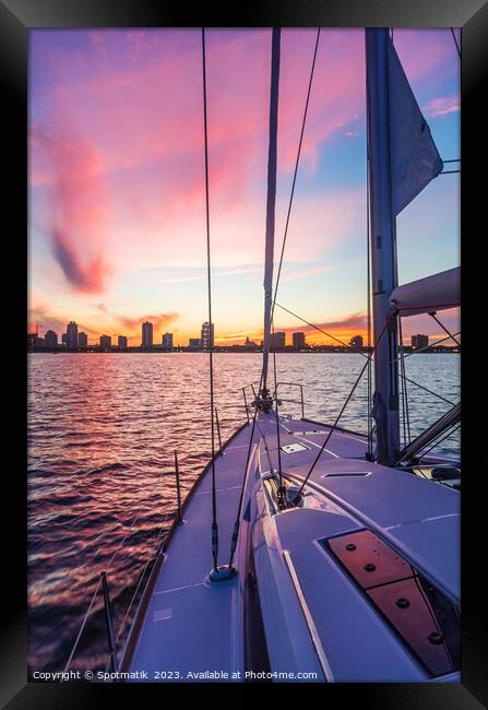 Sailing luxury yacht at sunset with cityscape view Framed Print by Spotmatik 