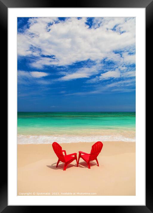 Red chairs on sandy beach by ocean Bahamas Framed Mounted Print by Spotmatik 