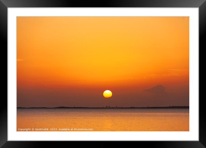 Tropical ocean view with orange sky at sunset Framed Mounted Print by Spotmatik 