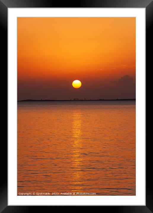 Orange sky with sunset reflection on tropical ocean Framed Mounted Print by Spotmatik 