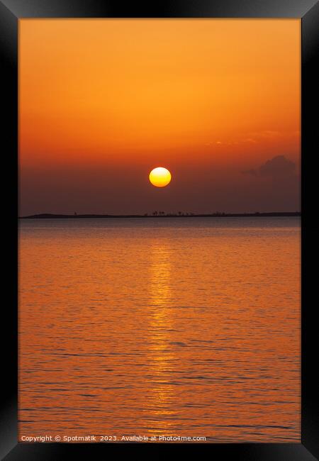 Orange sky with sunset reflection on tropical ocean Framed Print by Spotmatik 