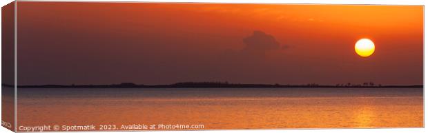 Panoramic ocean view at sunset with orange sky Canvas Print by Spotmatik 