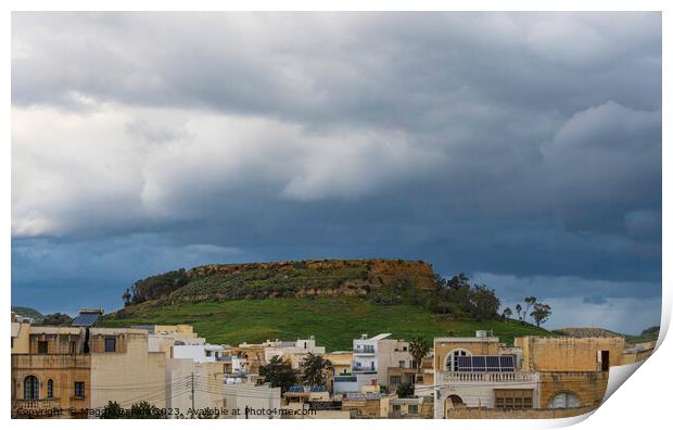 Storm over the hill with buildings, Gozo Island. Print by Maggie Bajada