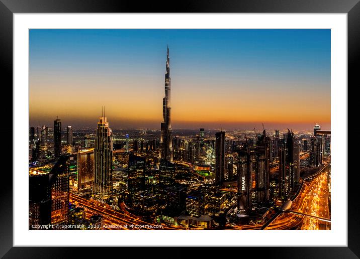 Aerial illuminated Dubai at sunset Burj Khalifa UAE Framed Mounted Print by Spotmatik 