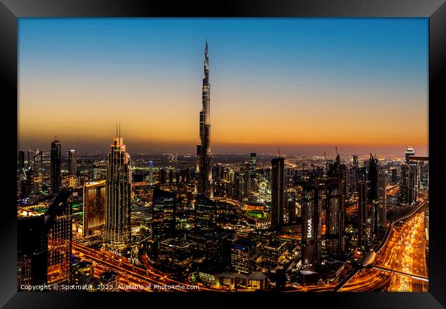 Aerial illuminated Dubai at sunset Burj Khalifa UAE Framed Print by Spotmatik 