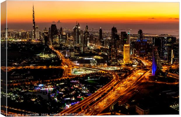 Aerial view of illuminated Dubai at sunset UAE  Canvas Print by Spotmatik 