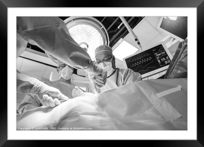 Medical surgical team wearing scrub operating  Framed Mounted Print by Spotmatik 
