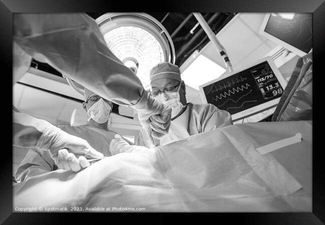 Medical surgical team wearing scrub operating  Framed Print by Spotmatik 