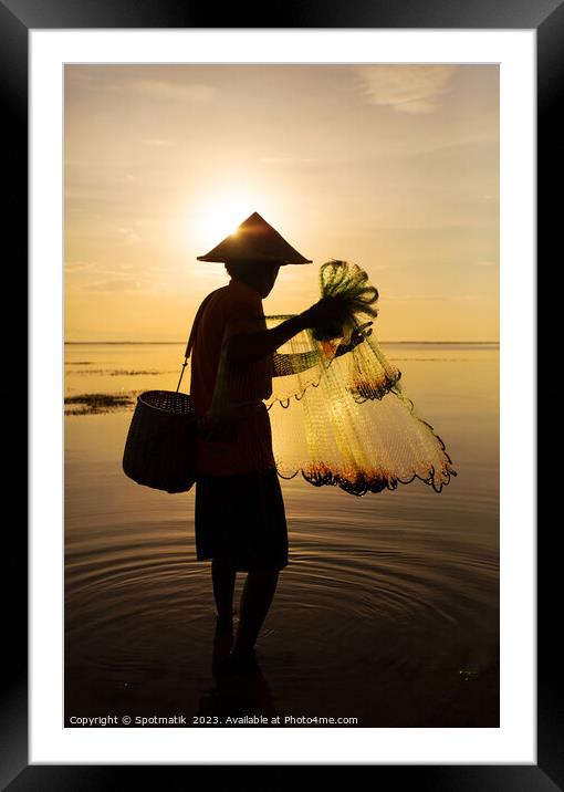 Silhouette Balinese male fishing Indonesian coastline at sunrise Framed Mounted Print by Spotmatik 