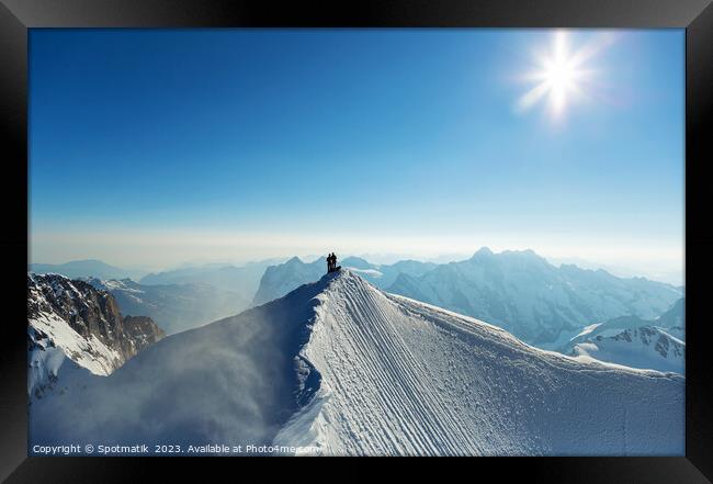 Aerial Switzerland mountaineers on snow covered Peak Europe Framed Print by Spotmatik 