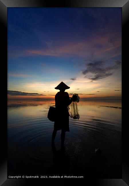 Balinese male fishing at sunrise Flores sea coastline  Framed Print by Spotmatik 
