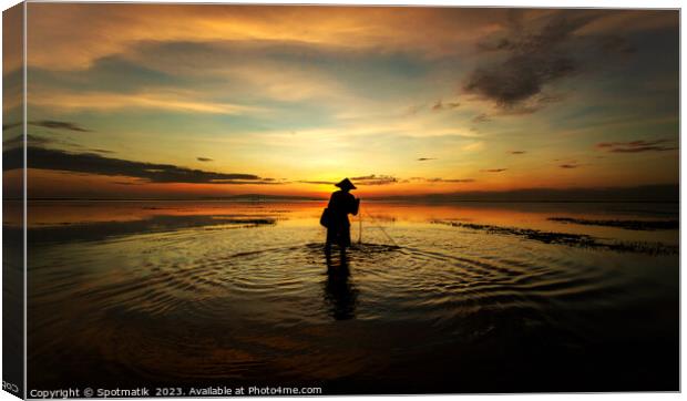 Balinese fisherman casting net Flores sea at sunrise Canvas Print by Spotmatik 