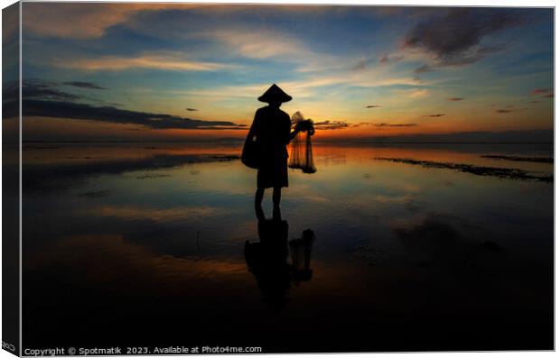 Silhouette Balinese male fishing Indonesian coastline at sunrise Canvas Print by Spotmatik 