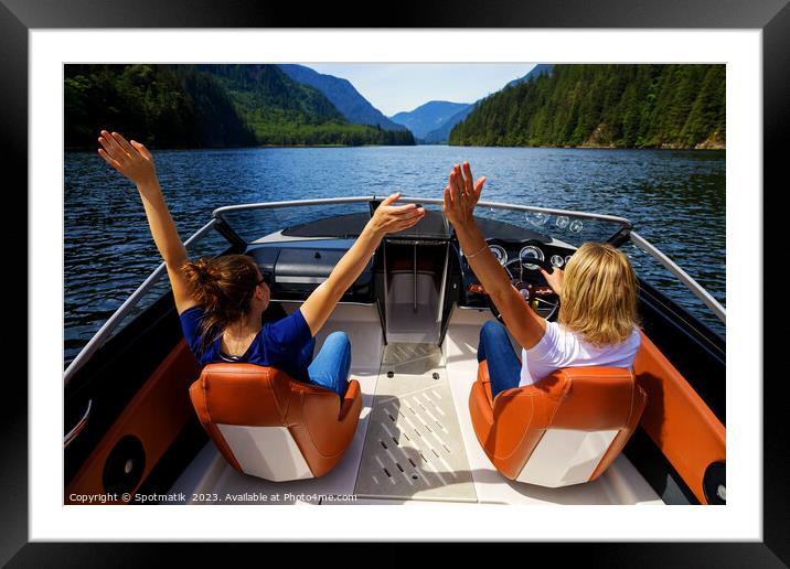 Female partners speeding across Vancouver mountain lake Framed Mounted Print by Spotmatik 