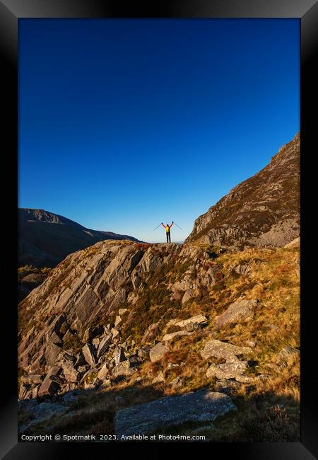 Happy female backpacker on rugged mountain peak Snowdonia Framed Print by Spotmatik 
