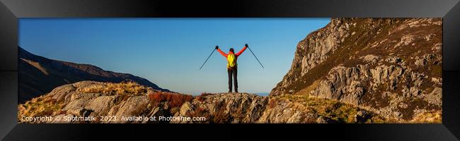 Panoramic happy female backpacker nearing mountain summit Framed Print by Spotmatik 