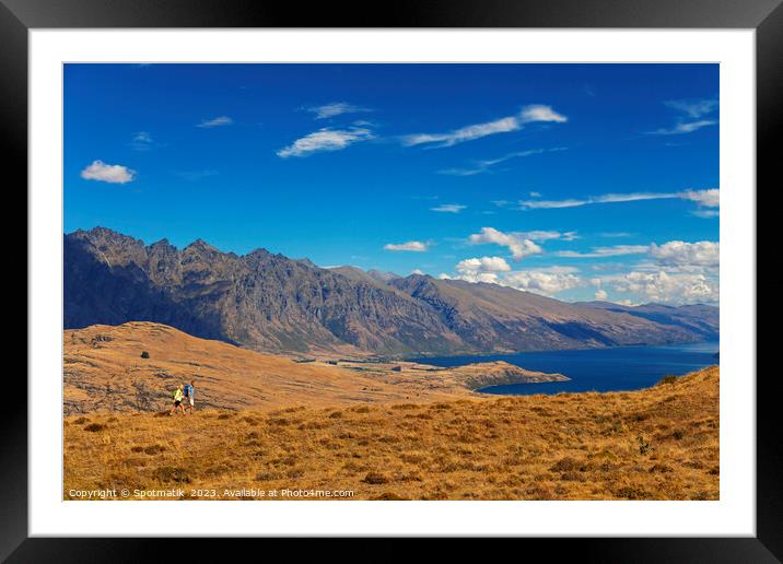 Mature backpacking couple hiking in remote mountainous landscape Framed Mounted Print by Spotmatik 