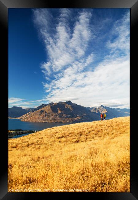 New Zealand trekking couple viewing Lake Wakatipu Otago Framed Print by Spotmatik 