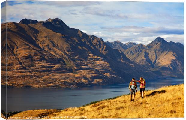 Hikers on trekking expedition enjoying view Lake Wakatipu  Canvas Print by Spotmatik 