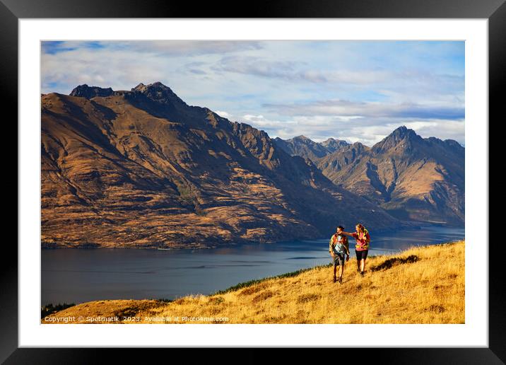 Hikers on trekking expedition enjoying view Lake Wakatipu  Framed Mounted Print by Spotmatik 