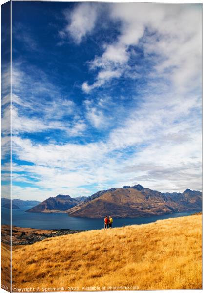 Male female hikers viewing Lake Wakatipu New Zealand  Canvas Print by Spotmatik 