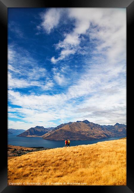 Male female hikers viewing Lake Wakatipu New Zealand  Framed Print by Spotmatik 
