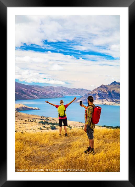 Hiking male using smartphone Outdoor picture of girlfriend Framed Mounted Print by Spotmatik 