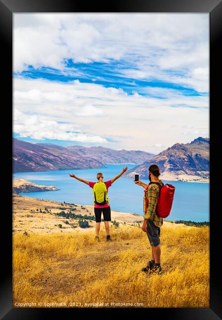 Hiking male using smartphone Outdoor picture of girlfriend Framed Print by Spotmatik 