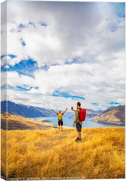 Young male taking picture of female friend Queenstown Canvas Print by Spotmatik 
